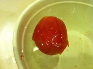 Tomato in ice bath. Peel coming away!